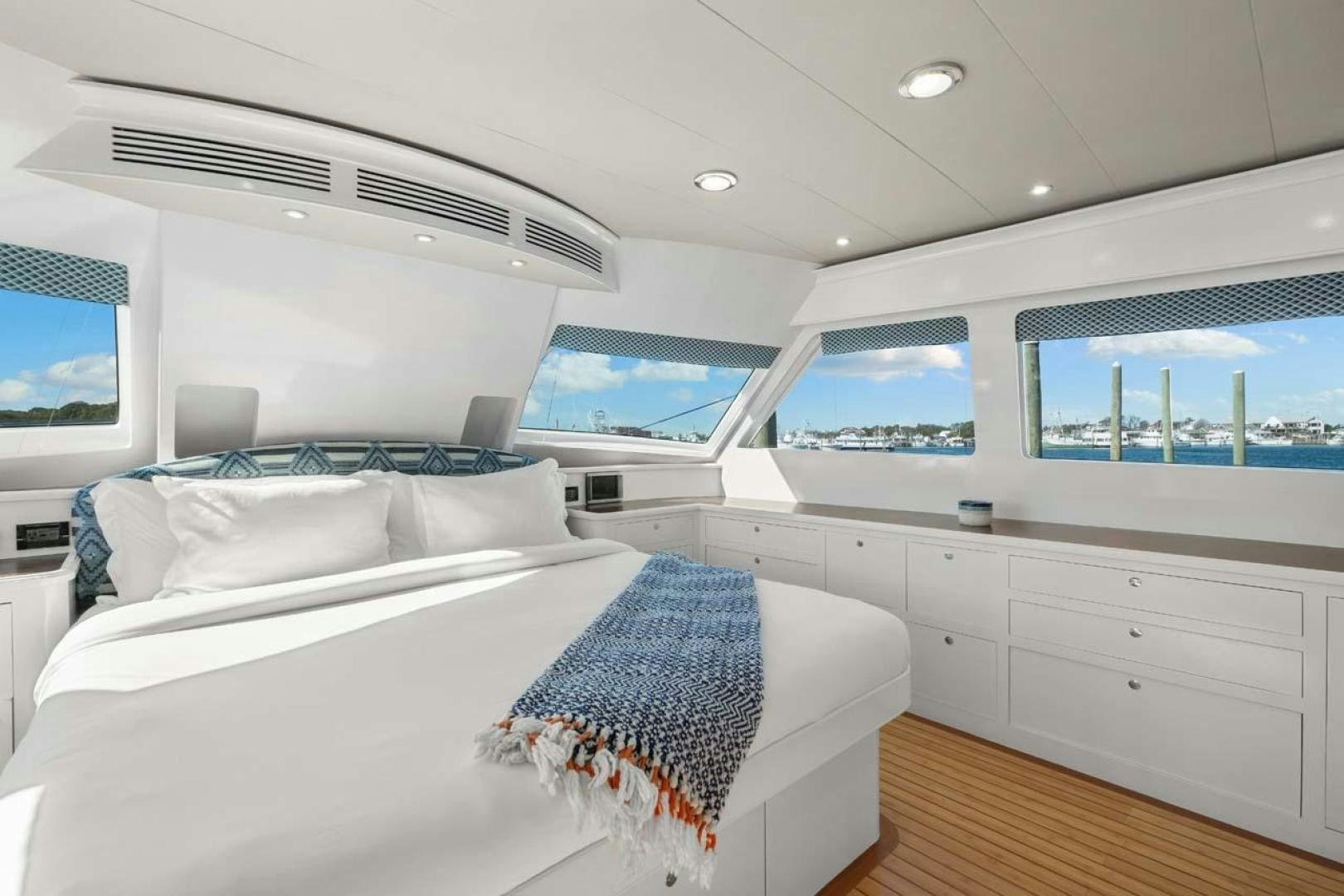 a room with a bed and a window aboard PIVOT Yacht for Sale