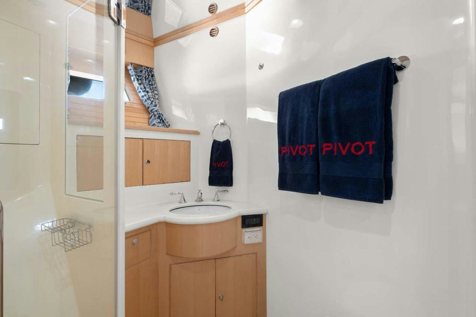 a bathroom with a sink and towels aboard PIVOT Yacht for Sale