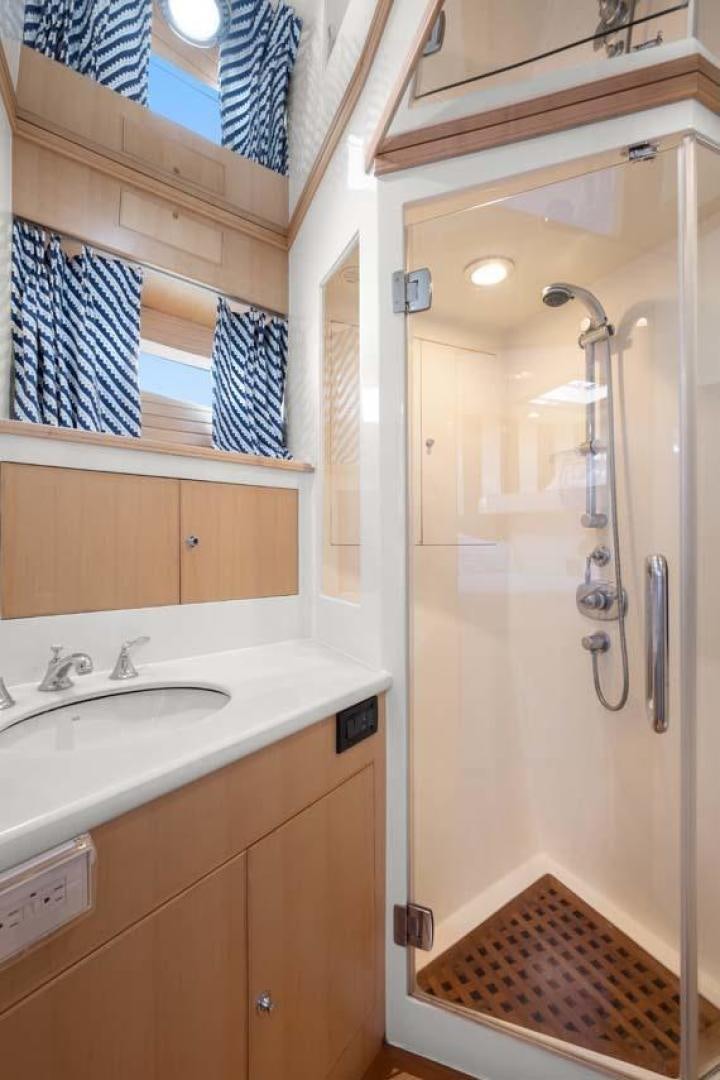 a bathroom with a shower and sink aboard PIVOT Yacht for Sale