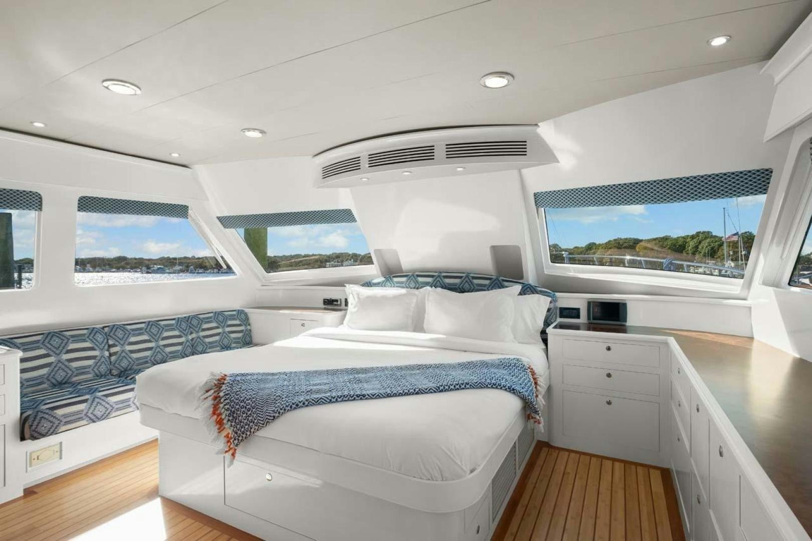 a room with a bed and a window aboard PIVOT Yacht for Sale