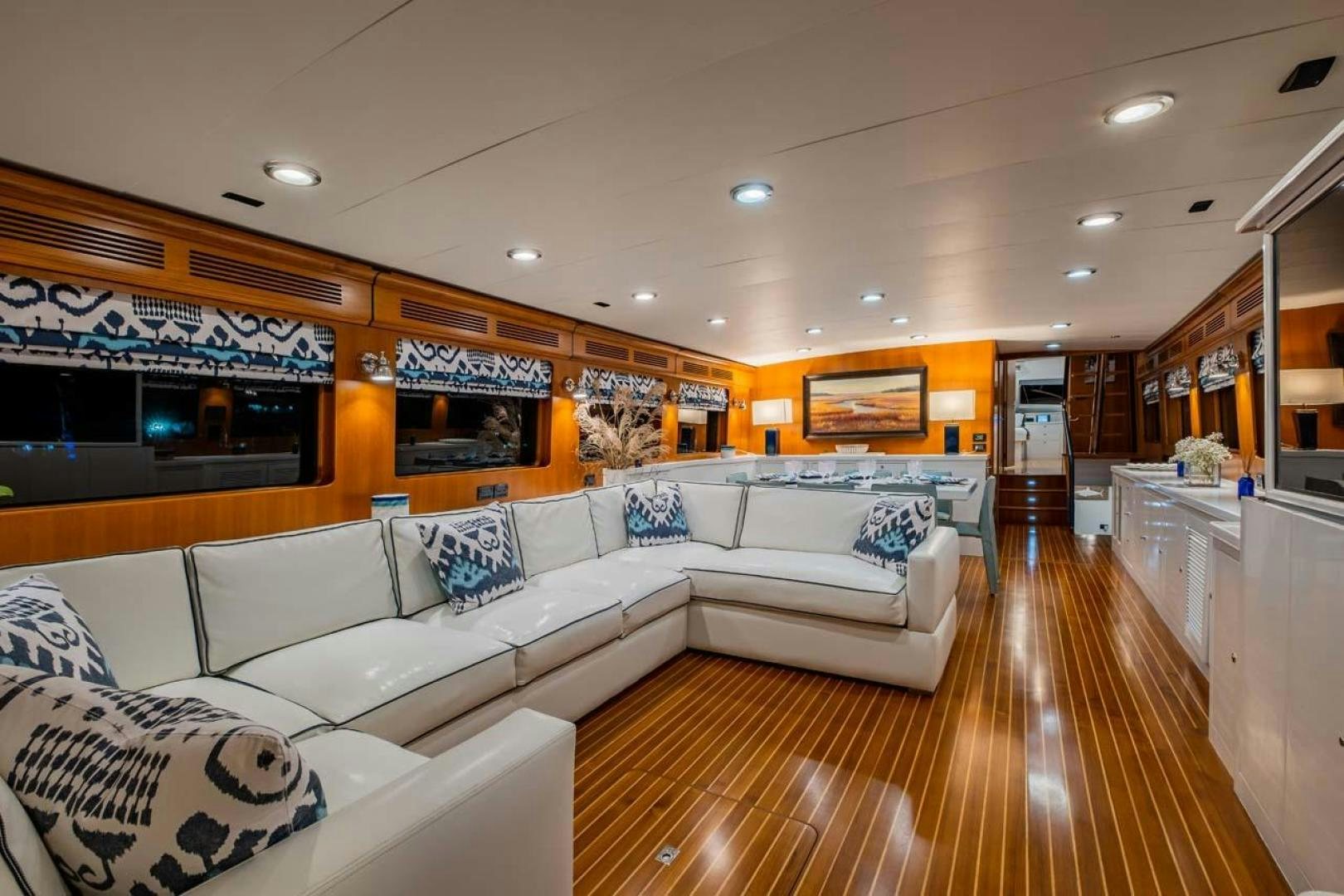 a large living room with a wood floor aboard PIVOT Yacht for Sale