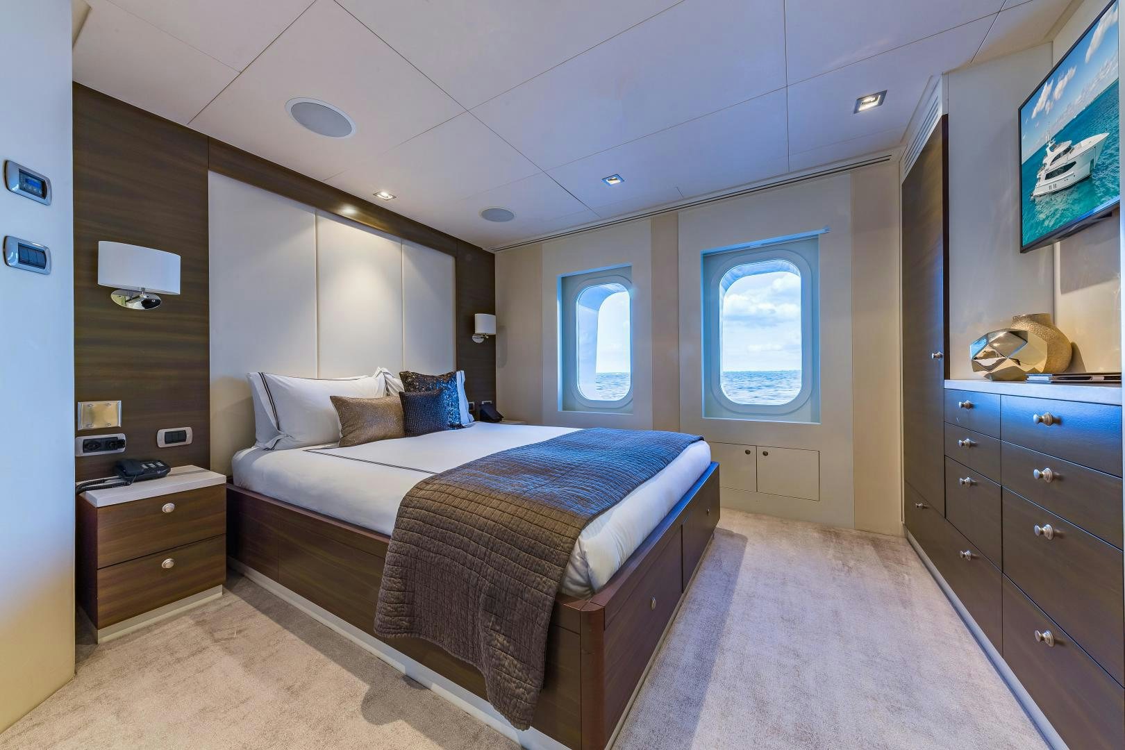 a bedroom with a bed and a tv aboard BIG SKY Yacht for Sale