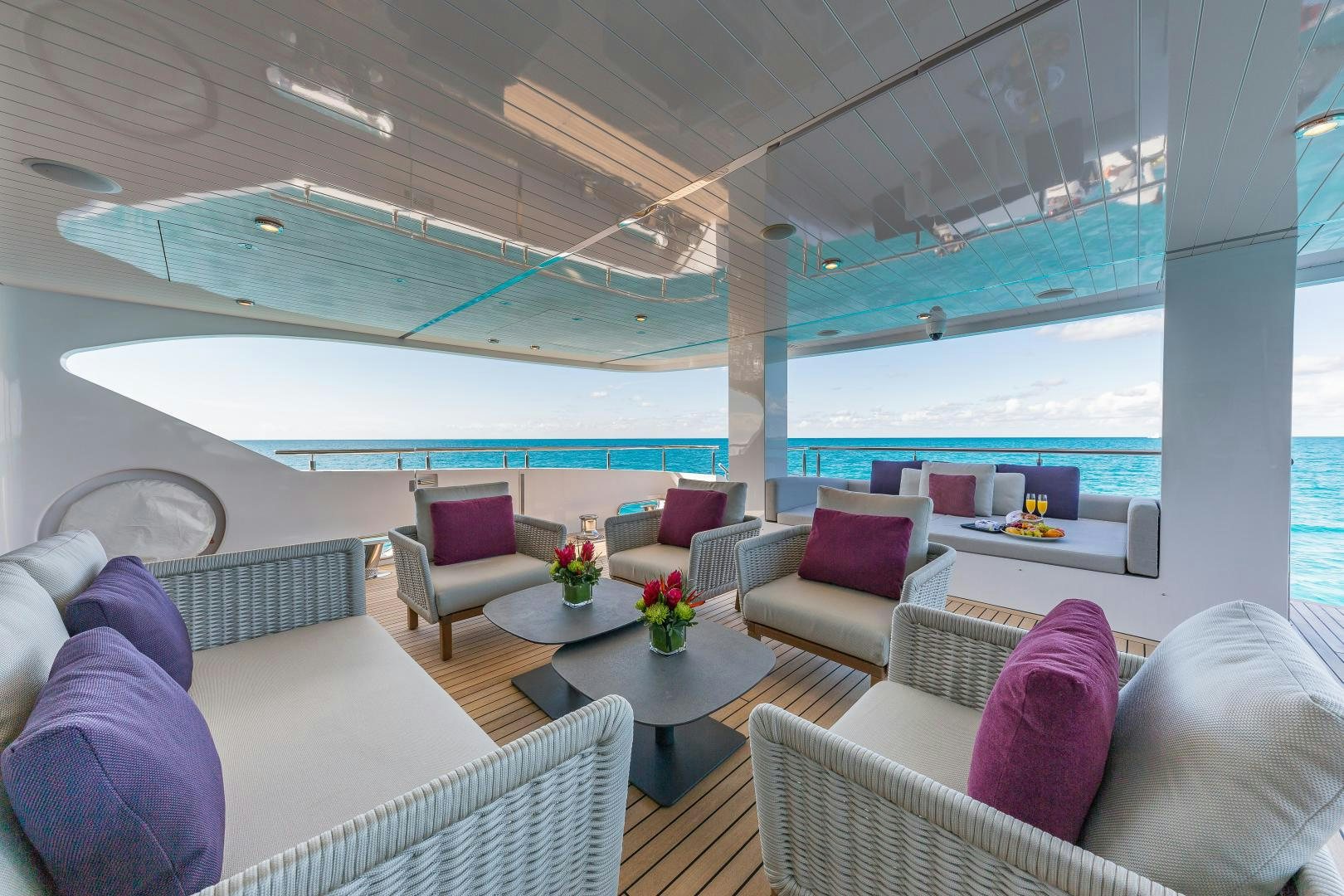 a living room with a large balcony aboard BIG SKY Yacht for Sale