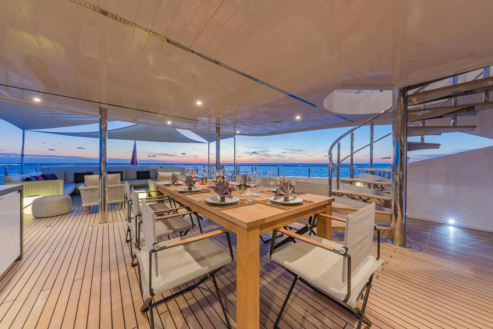 a table and chairs in a room aboard BIG SKY Yacht for Sale