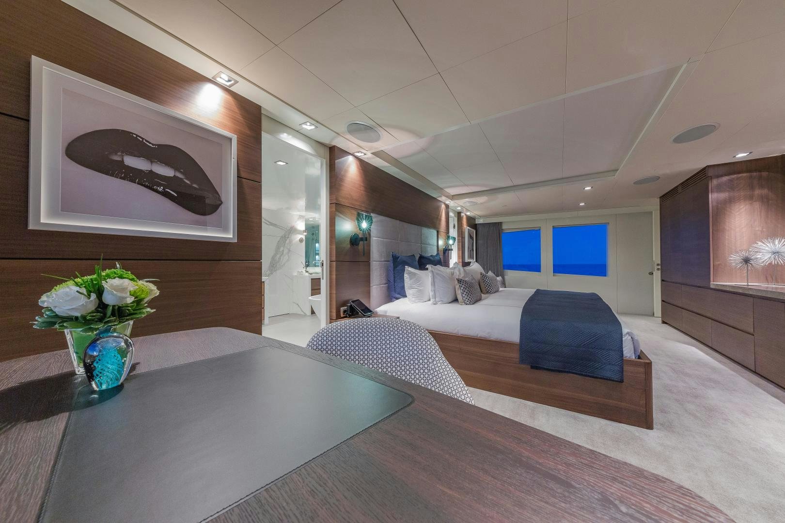 a room with a bed and a table aboard BIG SKY Yacht for Sale