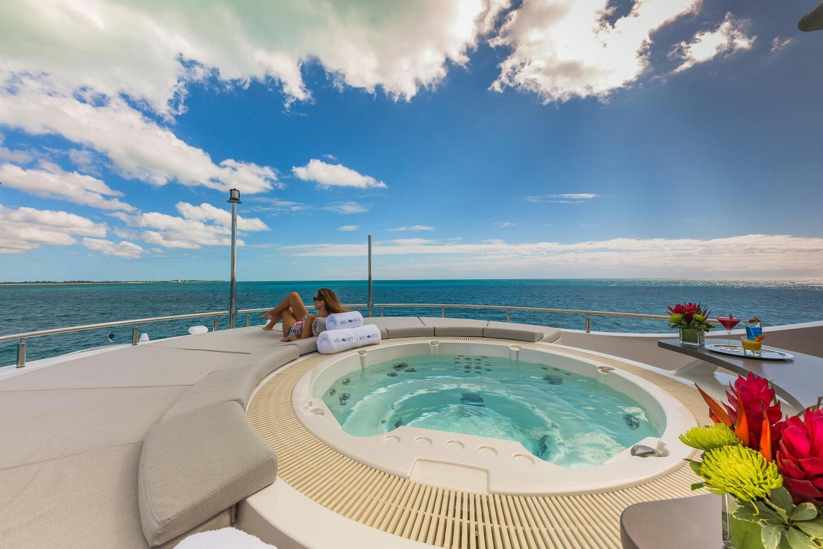 a person lying on a bathtub in a large body of water aboard BIG SKY Yacht for Sale