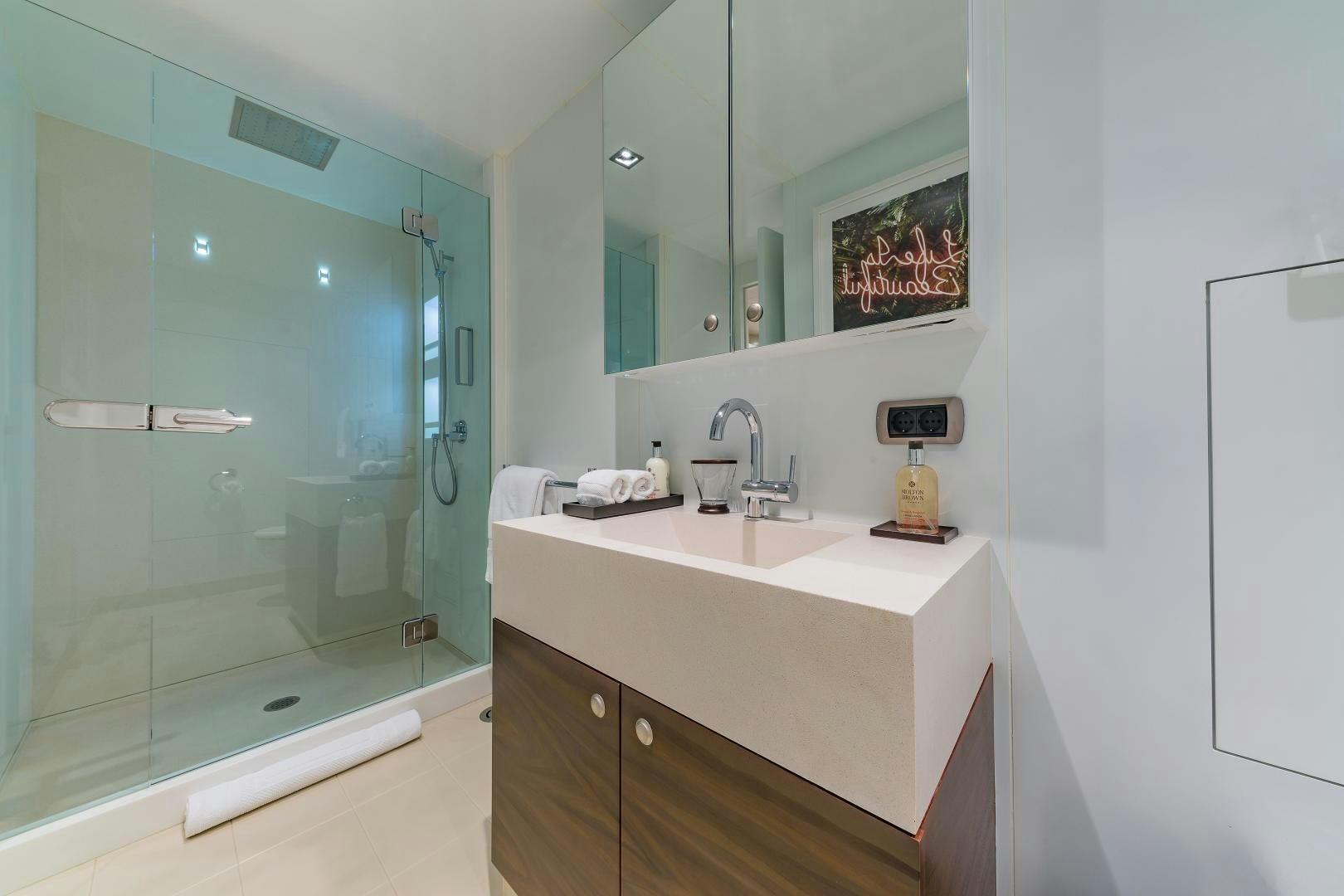 a bathroom with a glass shower aboard BIG SKY Yacht for Sale