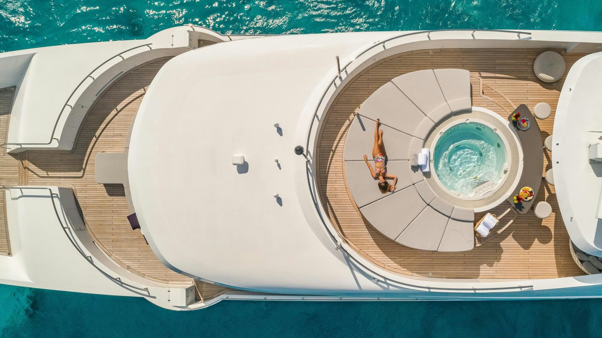 a person in a suit in a room with a toilet aboard BIG SKY Yacht for Sale