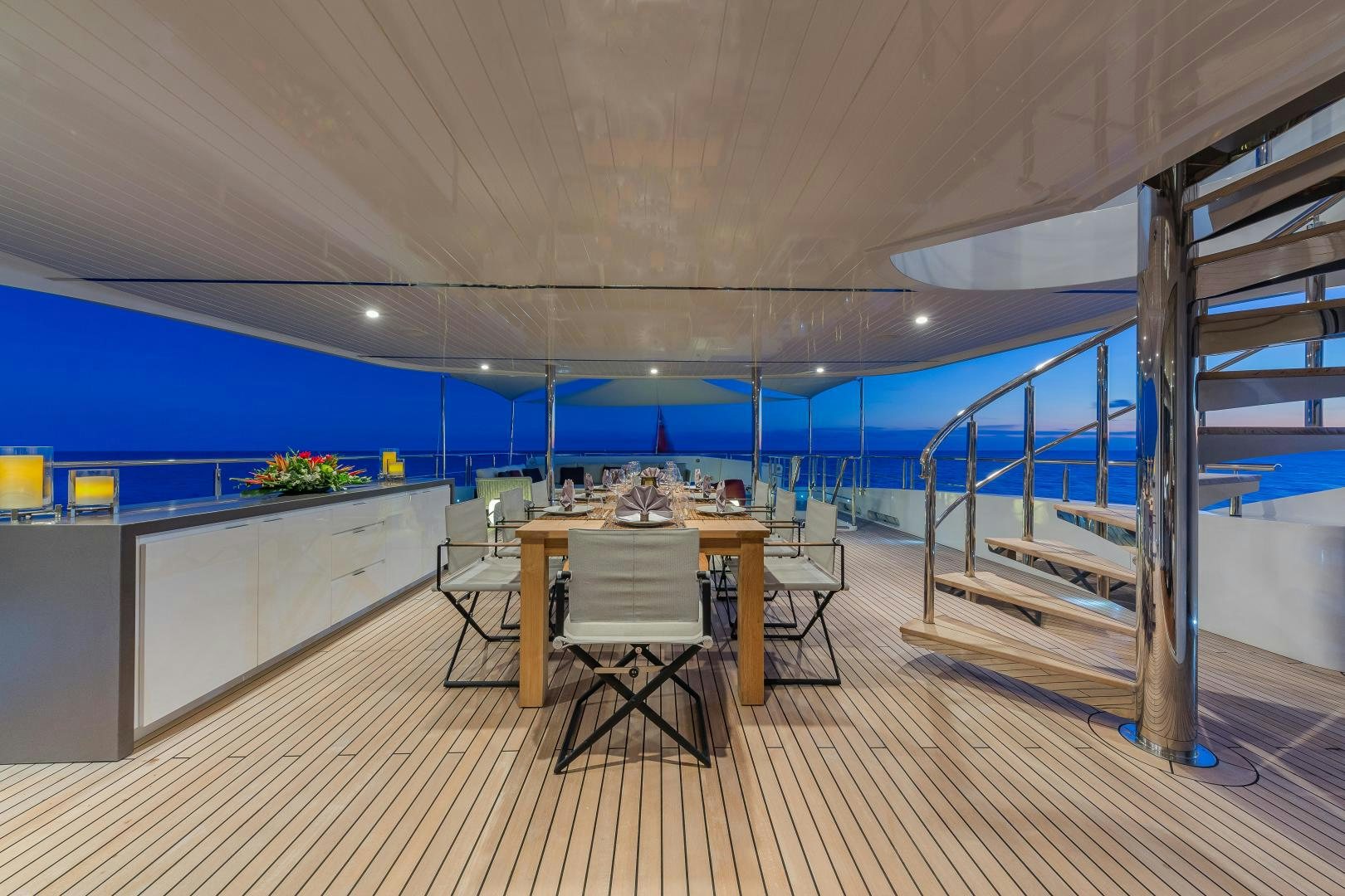 a room with a table and chairs aboard BIG SKY Yacht for Sale