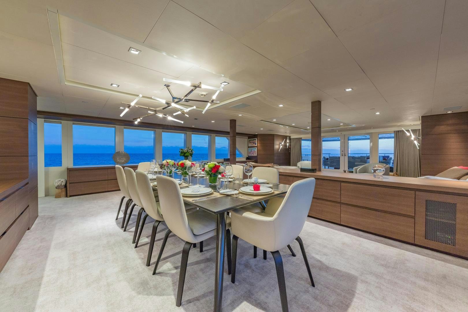 a large room with tables and chairs aboard BIG SKY Yacht for Sale