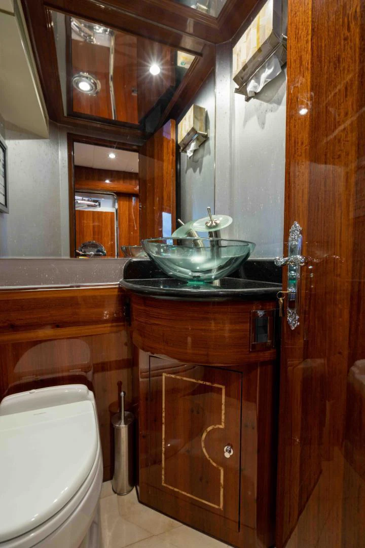 a bathroom with a sink and a toilet aboard NEVER SETTLE Yacht for Sale