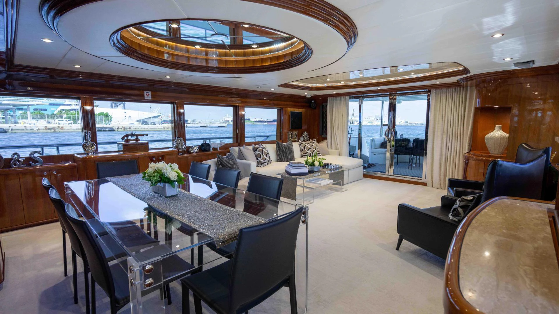 a large room with a table and chairs and a large chandelier aboard NEVER SETTLE Yacht for Sale