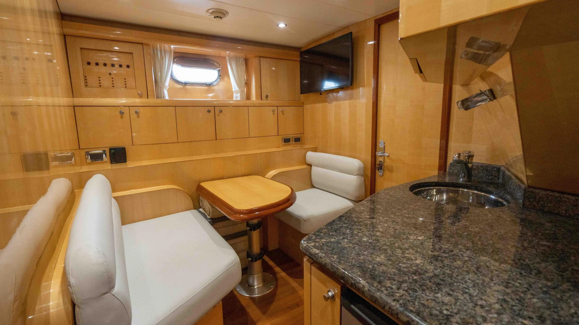 a bathroom with a countertop sink and a chair aboard NEVER SETTLE Yacht for Sale