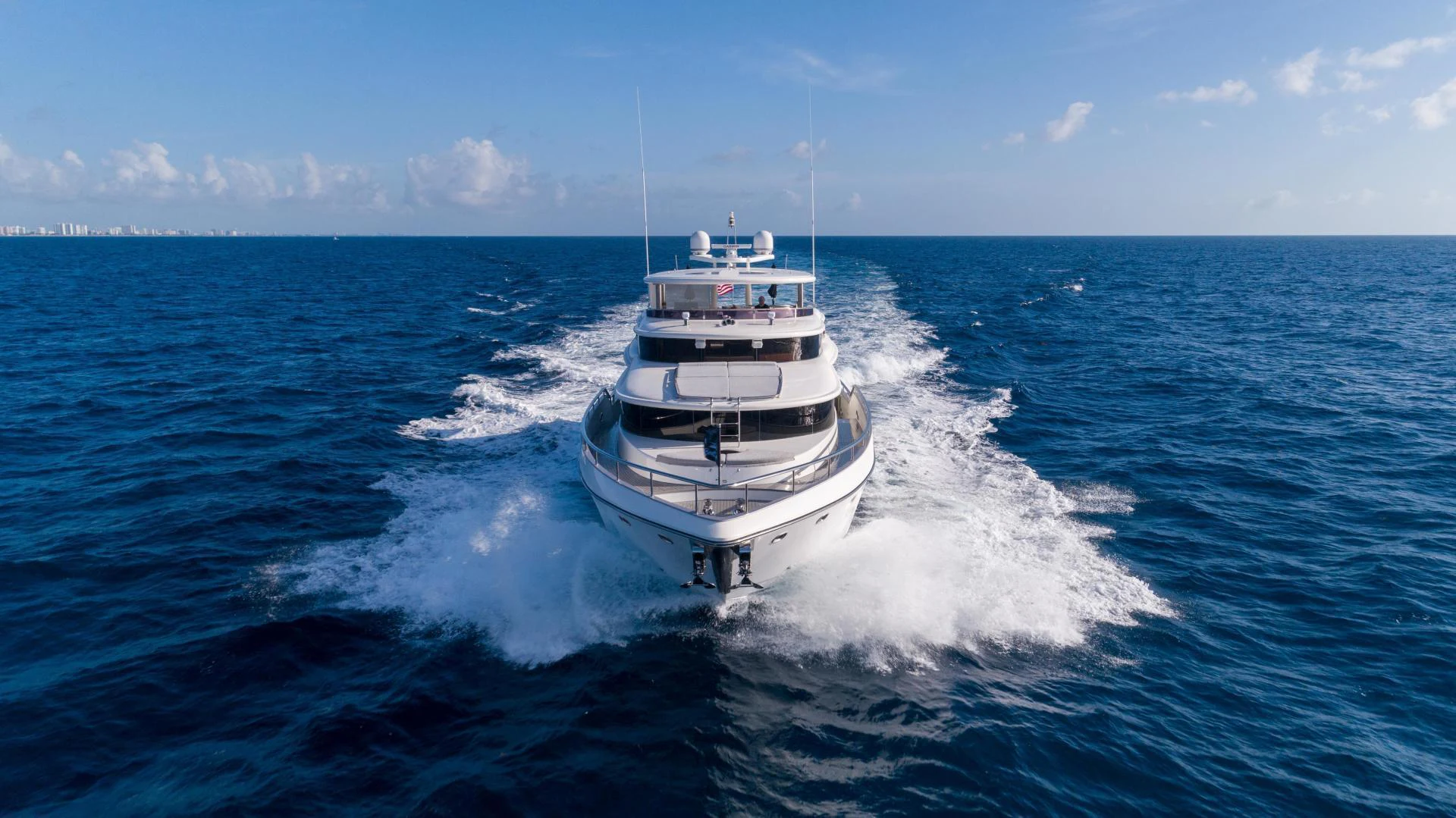 a large white ship in the water aboard NEVER SETTLE Yacht for Sale