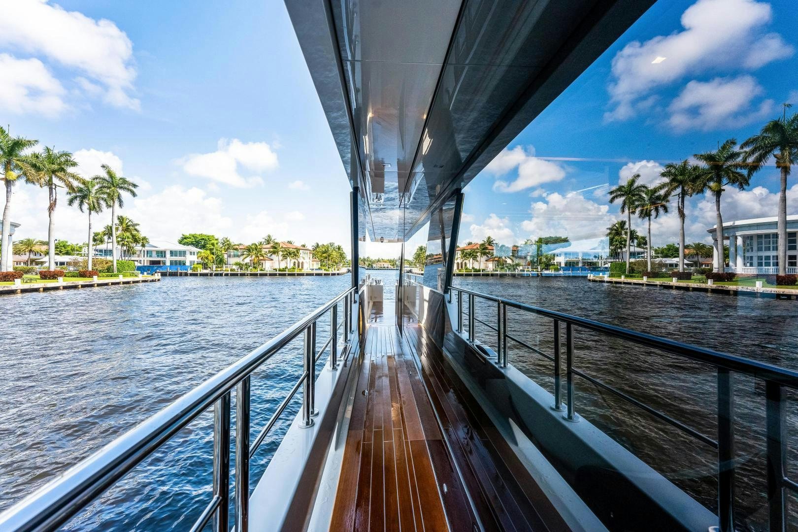 a deck with a large umbrella over it and a body of water aboard LIVING LIFE Yacht for Sale