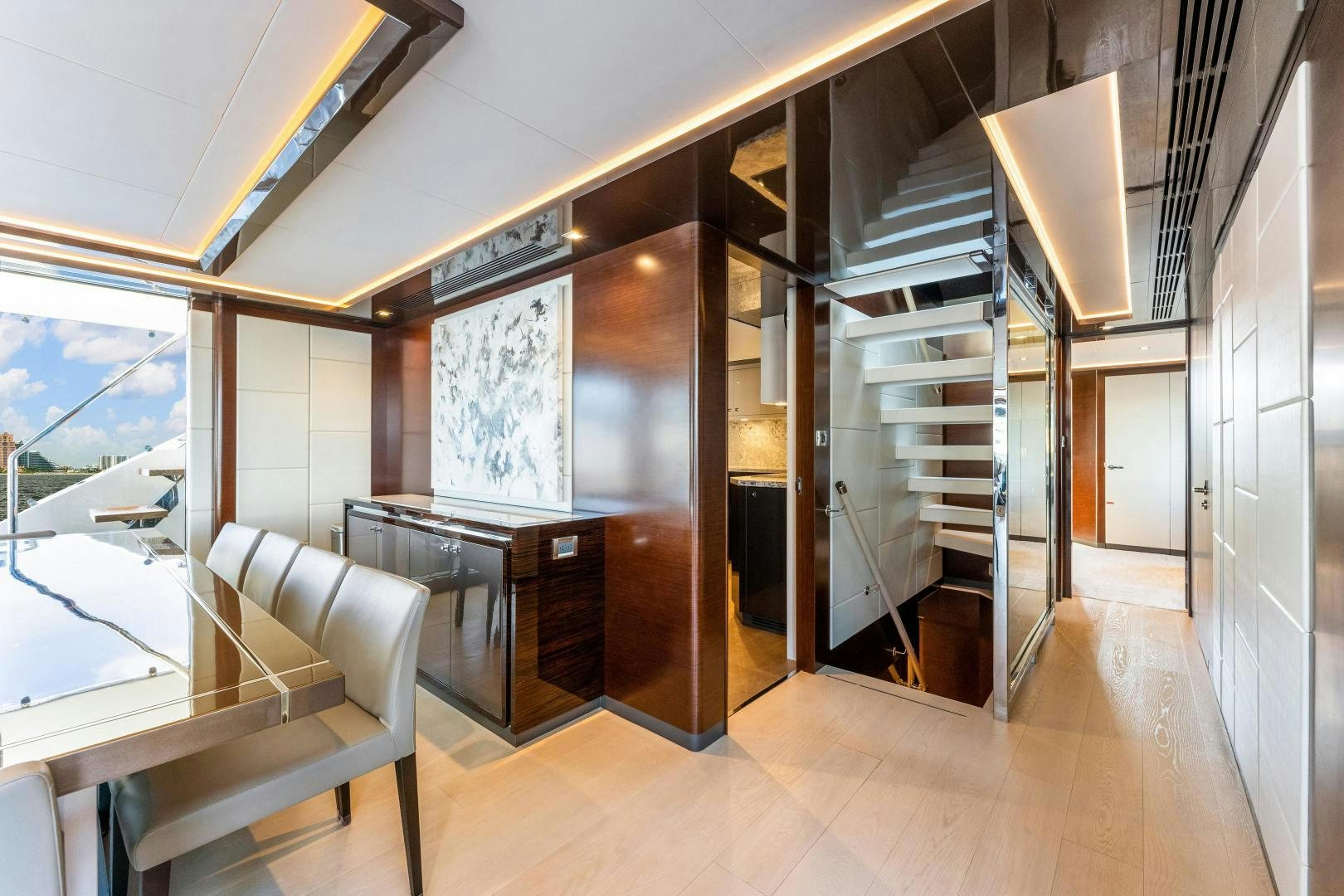 a room with a staircase and a table and chairs aboard LIVING LIFE Yacht for Sale
