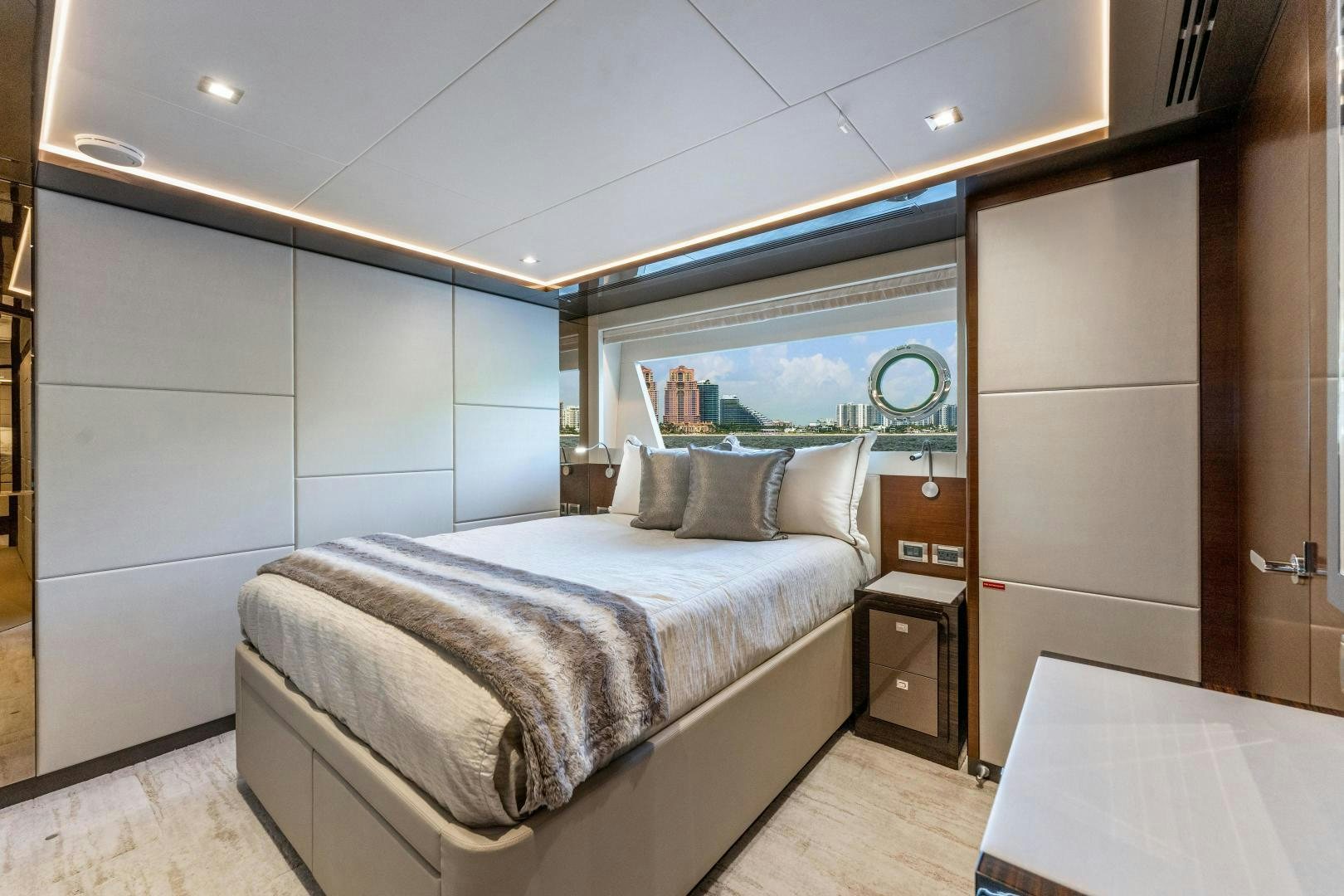 a room with a bed and a window aboard LIVING LIFE Yacht for Sale