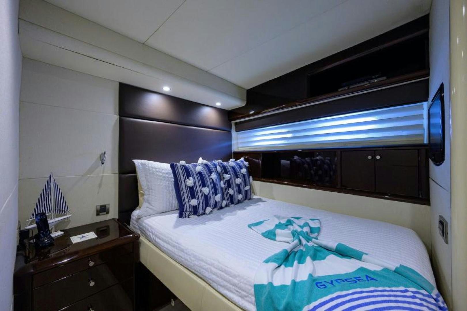 a bed with a blue sheet aboard GYPSEA Yacht for Sale