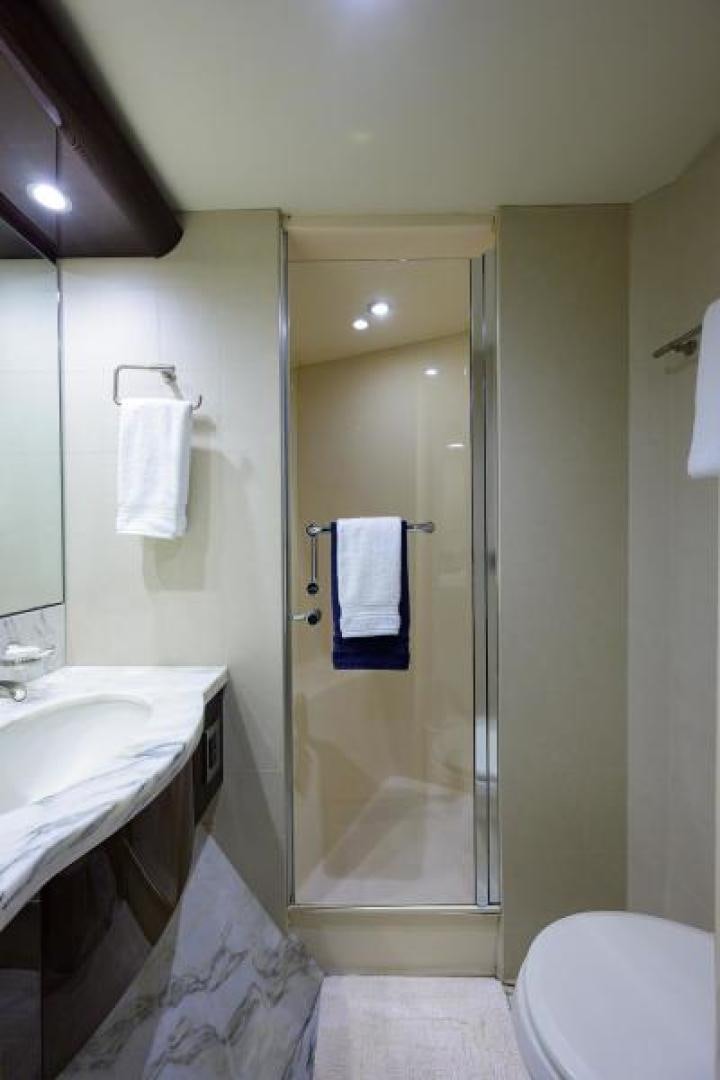 a bathroom with a glass shower aboard GYPSEA Yacht for Sale