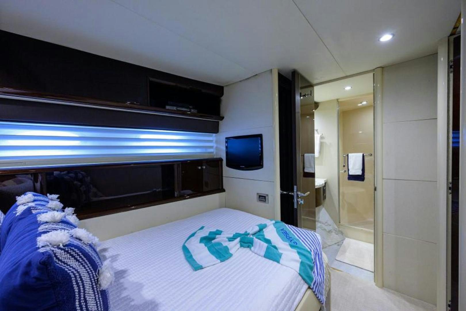 a bedroom with a bed and a television aboard GYPSEA Yacht for Sale
