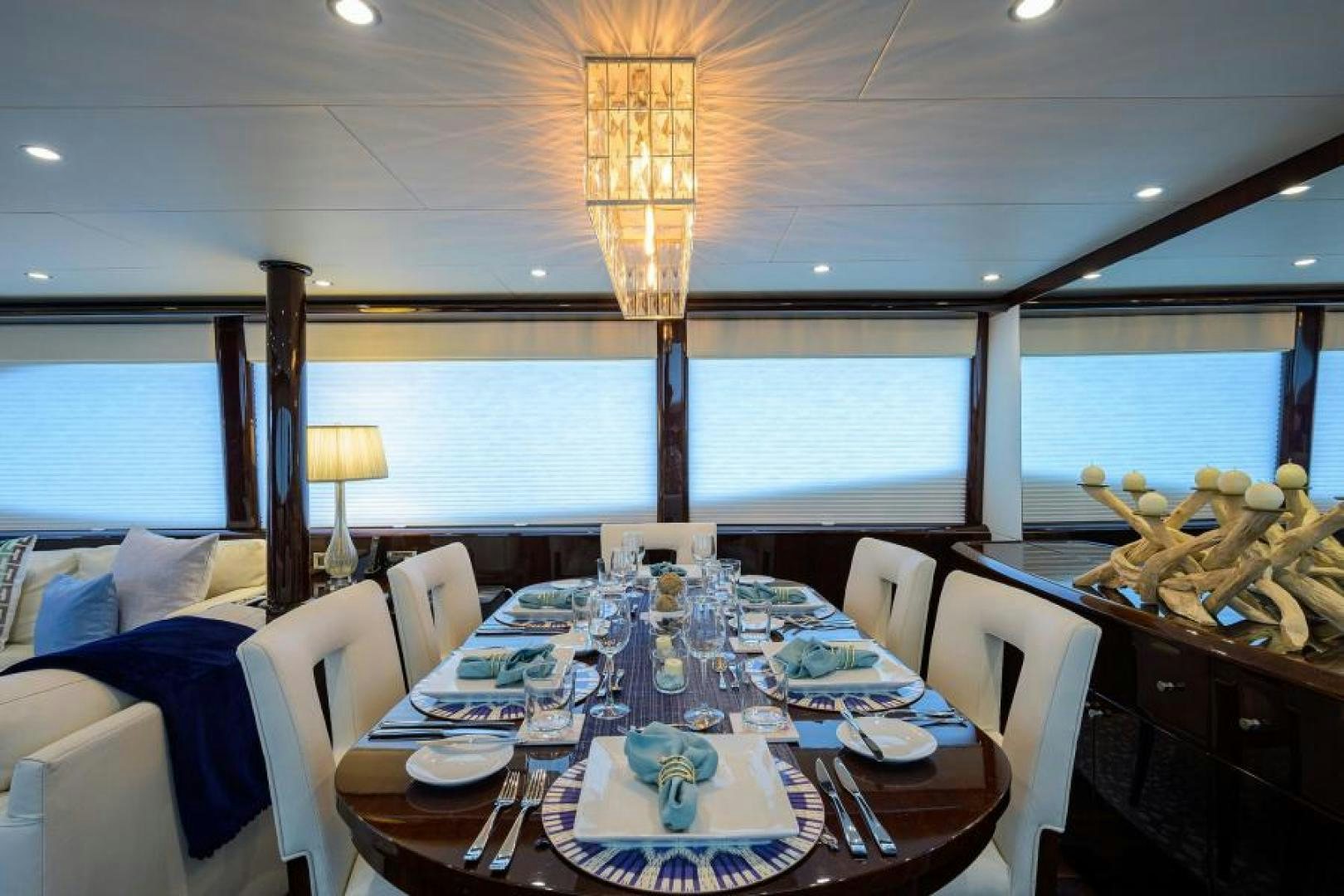 a dining room with a table set for a dinner aboard GYPSEA Yacht for Sale
