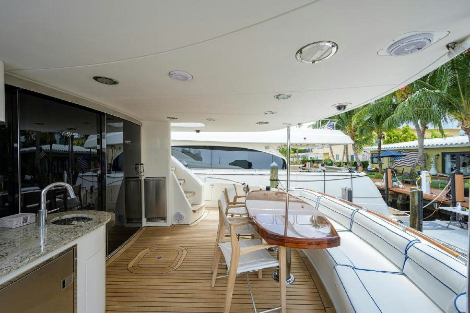 a deck with a table and chairs aboard GYPSEA Yacht for Sale