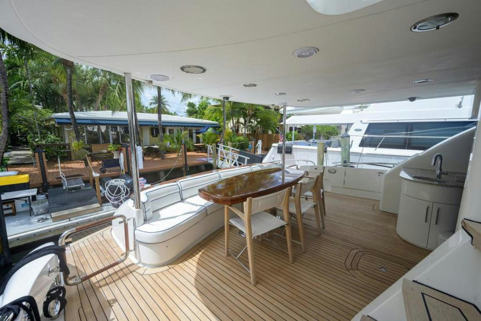 a deck with a table and chairs aboard GYPSEA Yacht for Sale