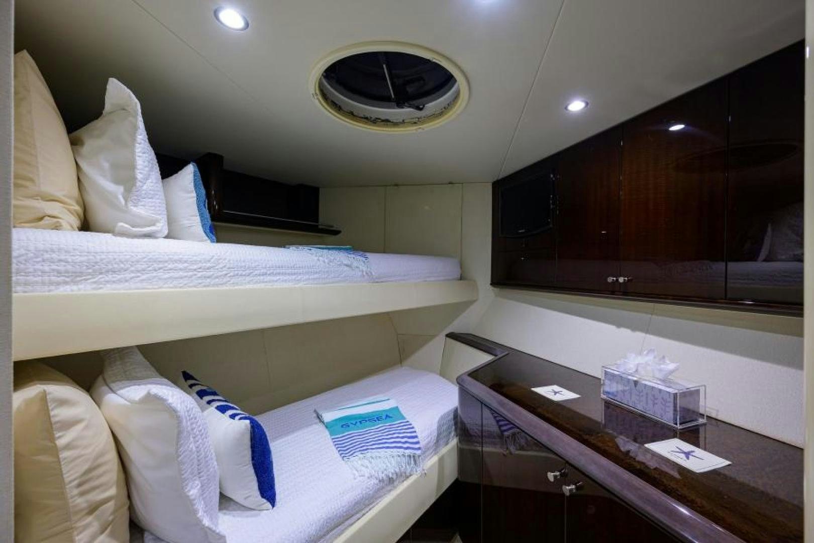 a room with beds and a table aboard GYPSEA Yacht for Sale