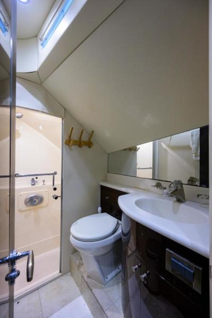 a bathroom with a toilet sink and a mirror aboard GYPSEA Yacht for Sale