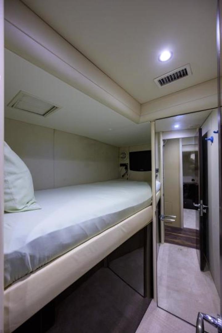 a room with a bed and a door aboard GYPSEA Yacht for Sale