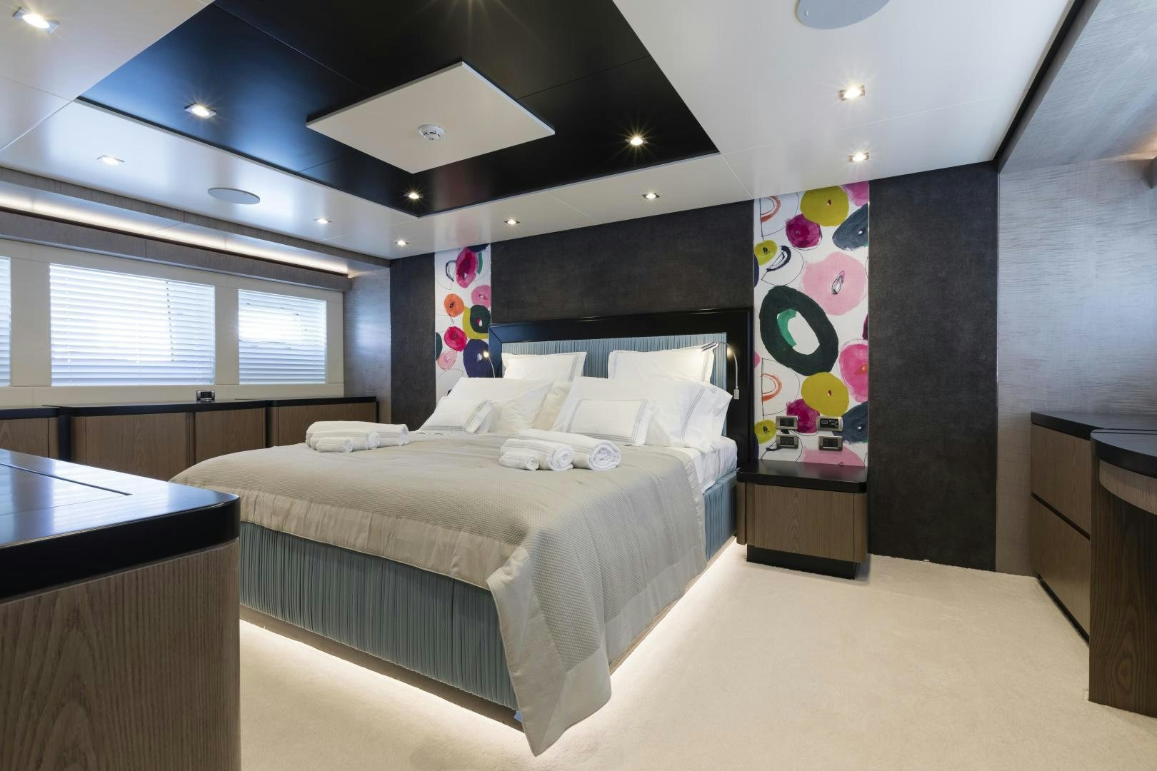 a bedroom with a bed and a desk aboard FRANCESCA Yacht for Sale