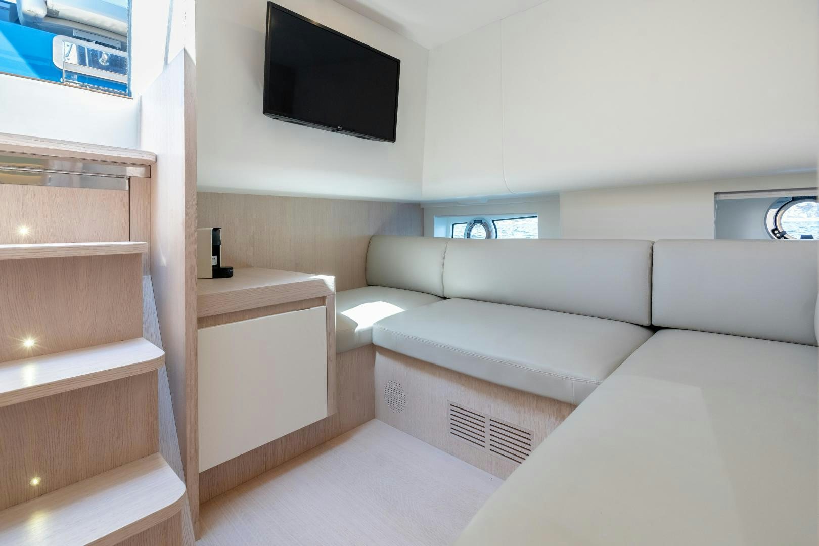 a room with a couch and a tv on the wall aboard CLAIR DE HUNE 2 Yacht for Sale