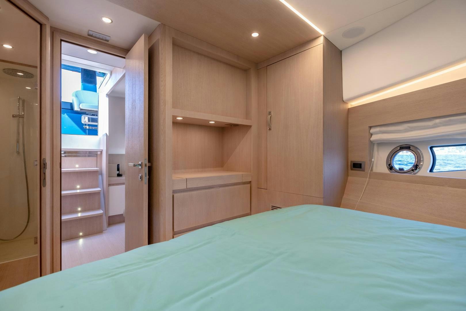 a room with a bed and a closet aboard CLAIR DE HUNE 2 Yacht for Sale