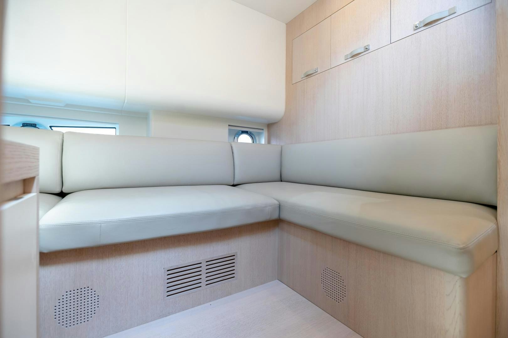 a white couch in a room aboard CLAIR DE HUNE 2 Yacht for Sale