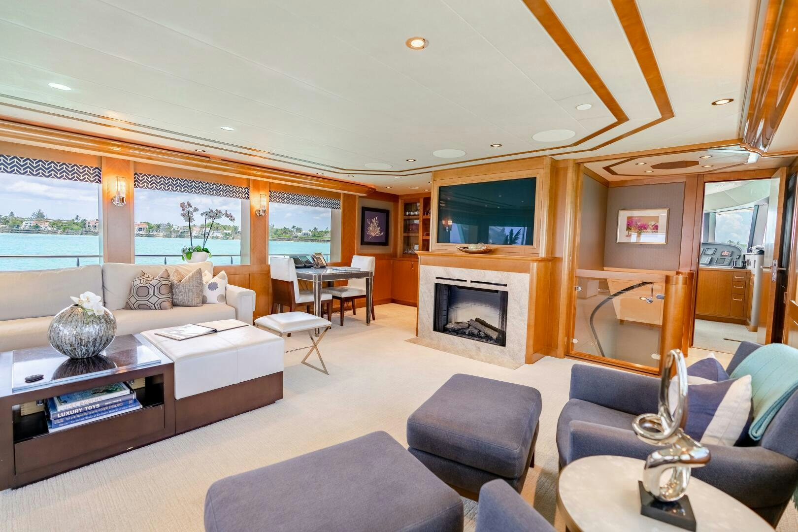 a living room with a fireplace aboard FAR NIENTE Yacht for Sale