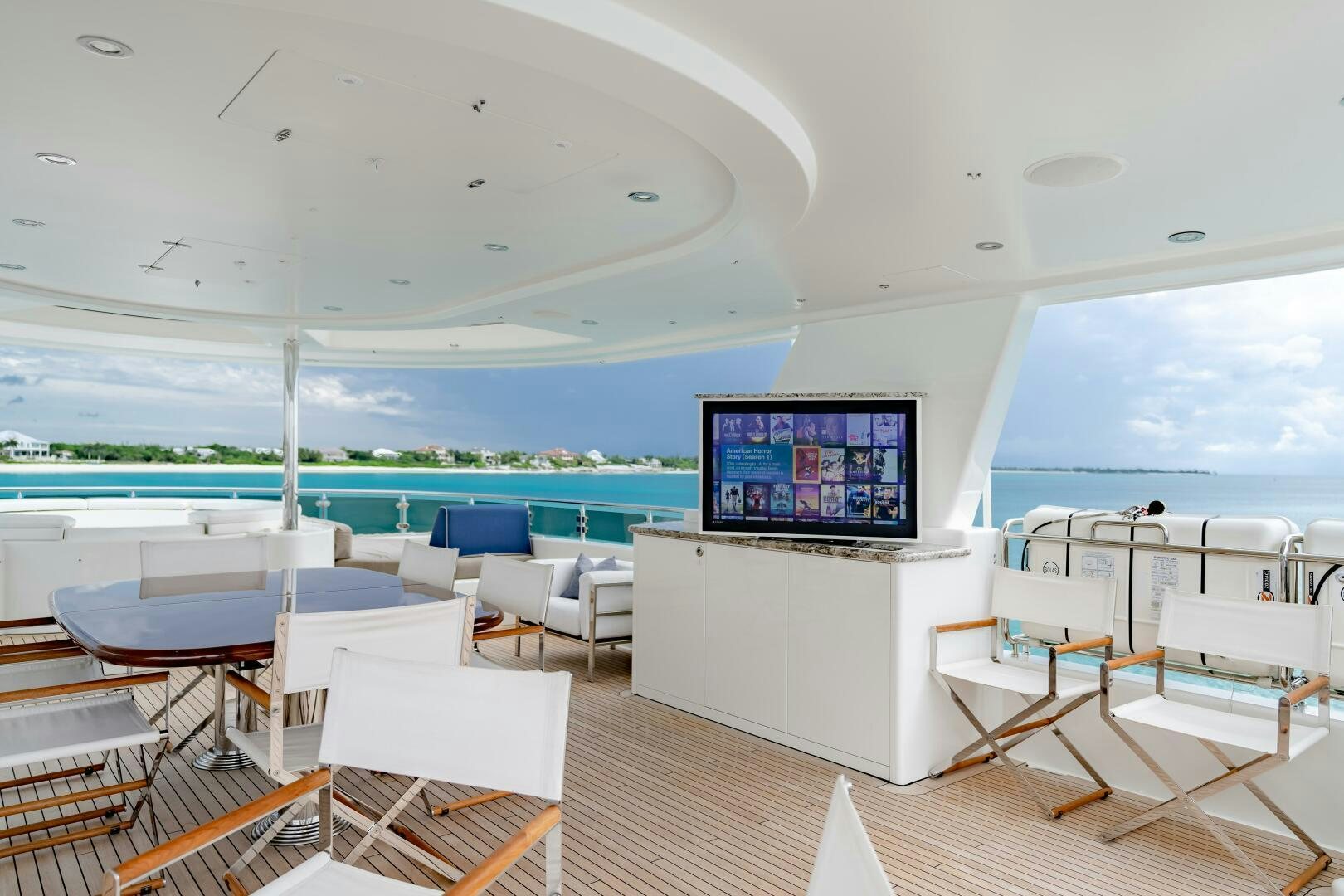 a room with a tv and chairs aboard FAR NIENTE Yacht for Sale