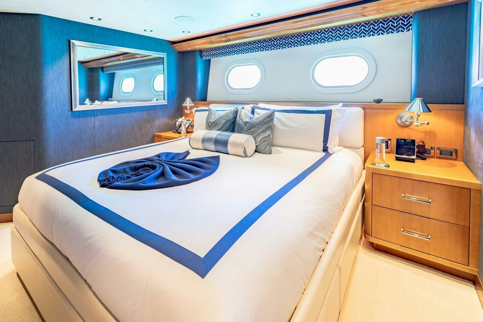 a bed with blue sheets aboard FAR NIENTE Yacht for Sale