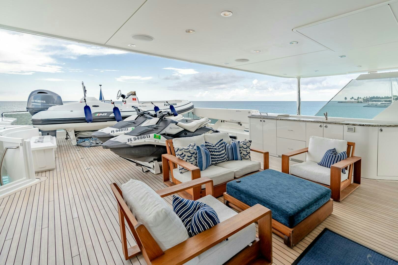 a room with a deck and chairs aboard FAR NIENTE Yacht for Sale