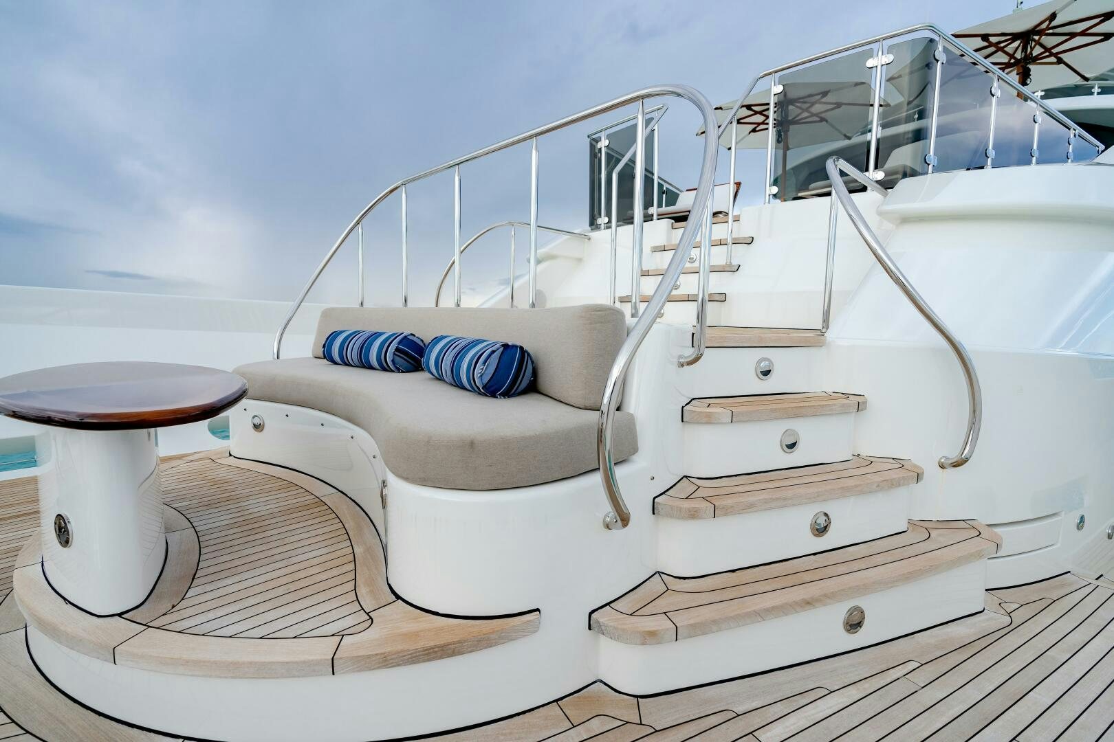a white boat with a blue pillow on a deck aboard FAR NIENTE Yacht for Sale