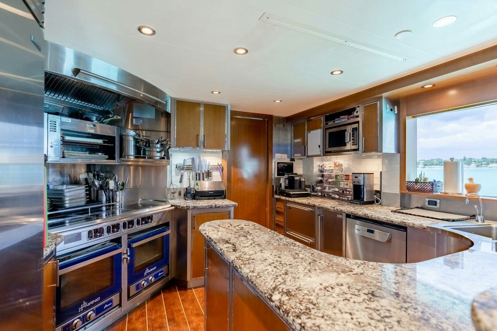 a large kitchen with a large island aboard FAR NIENTE Yacht for Sale