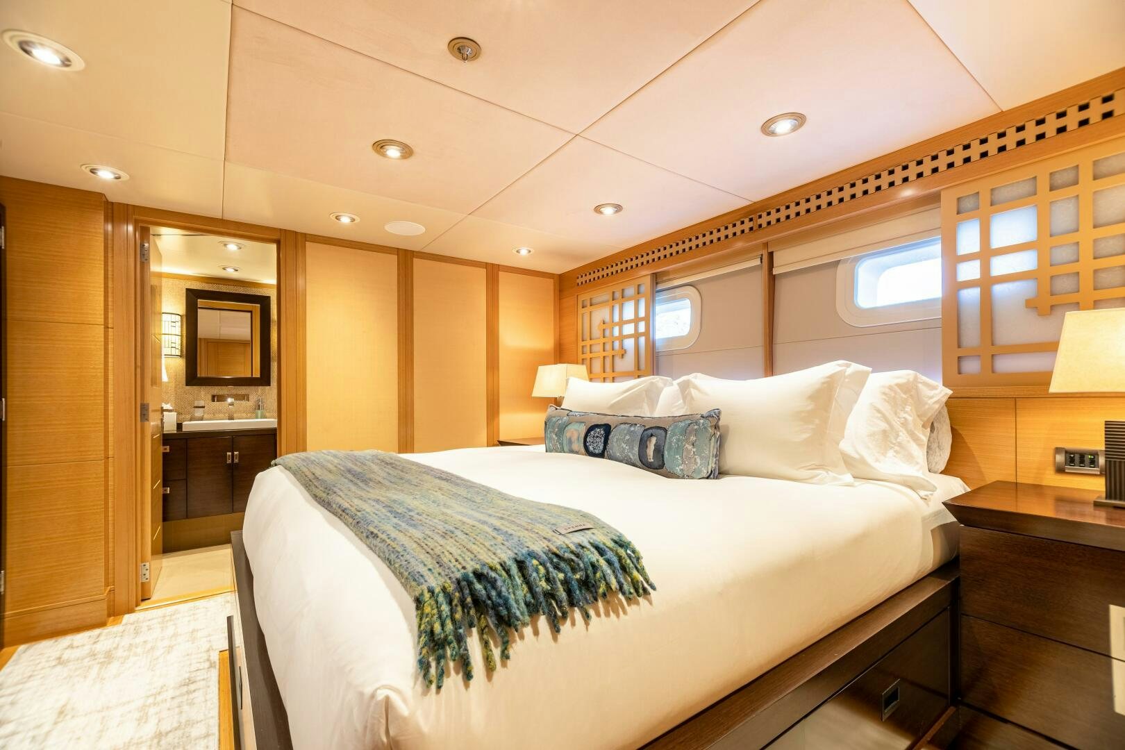 a bedroom with a bed and a mirror aboard ROCHADE Yacht for Sale