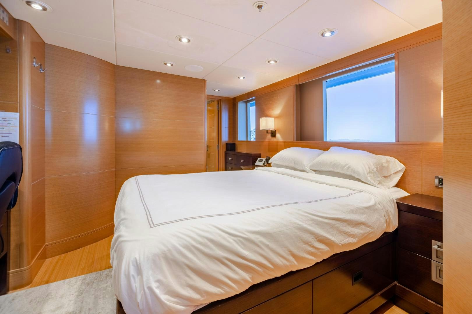 a room with a bed and a lamp aboard ROCHADE Yacht for Sale