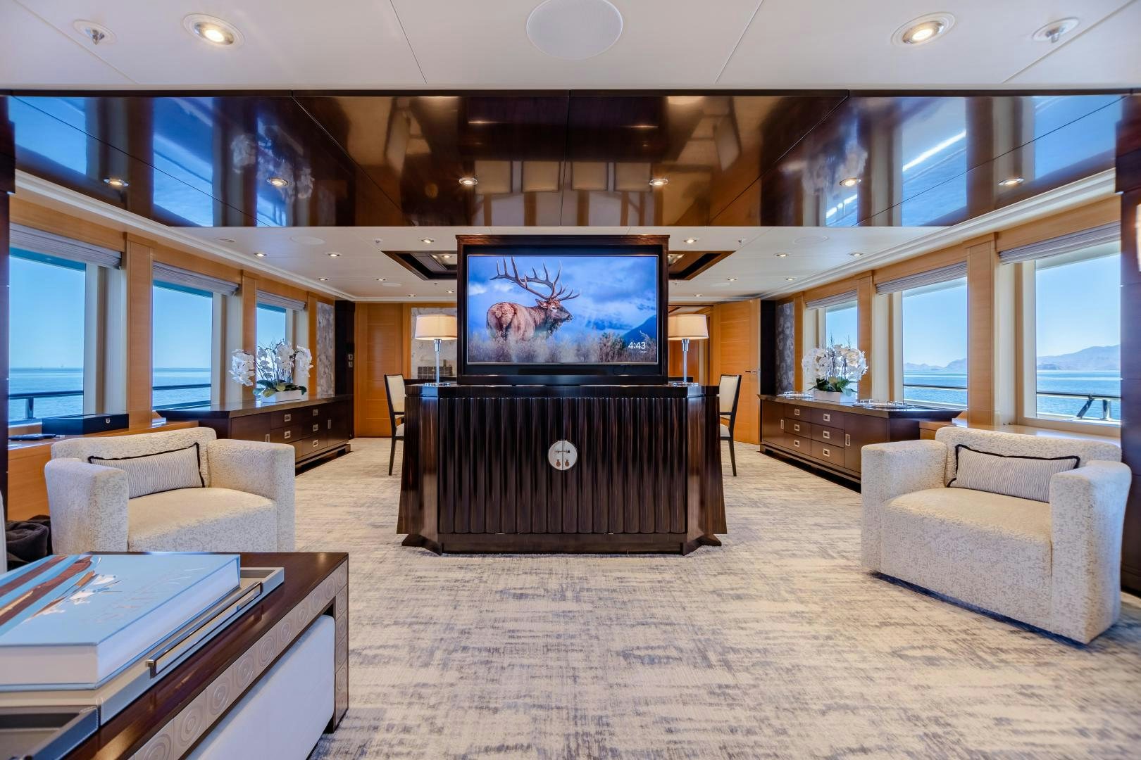 a large room with a tv and couches aboard ROCHADE Yacht for Sale