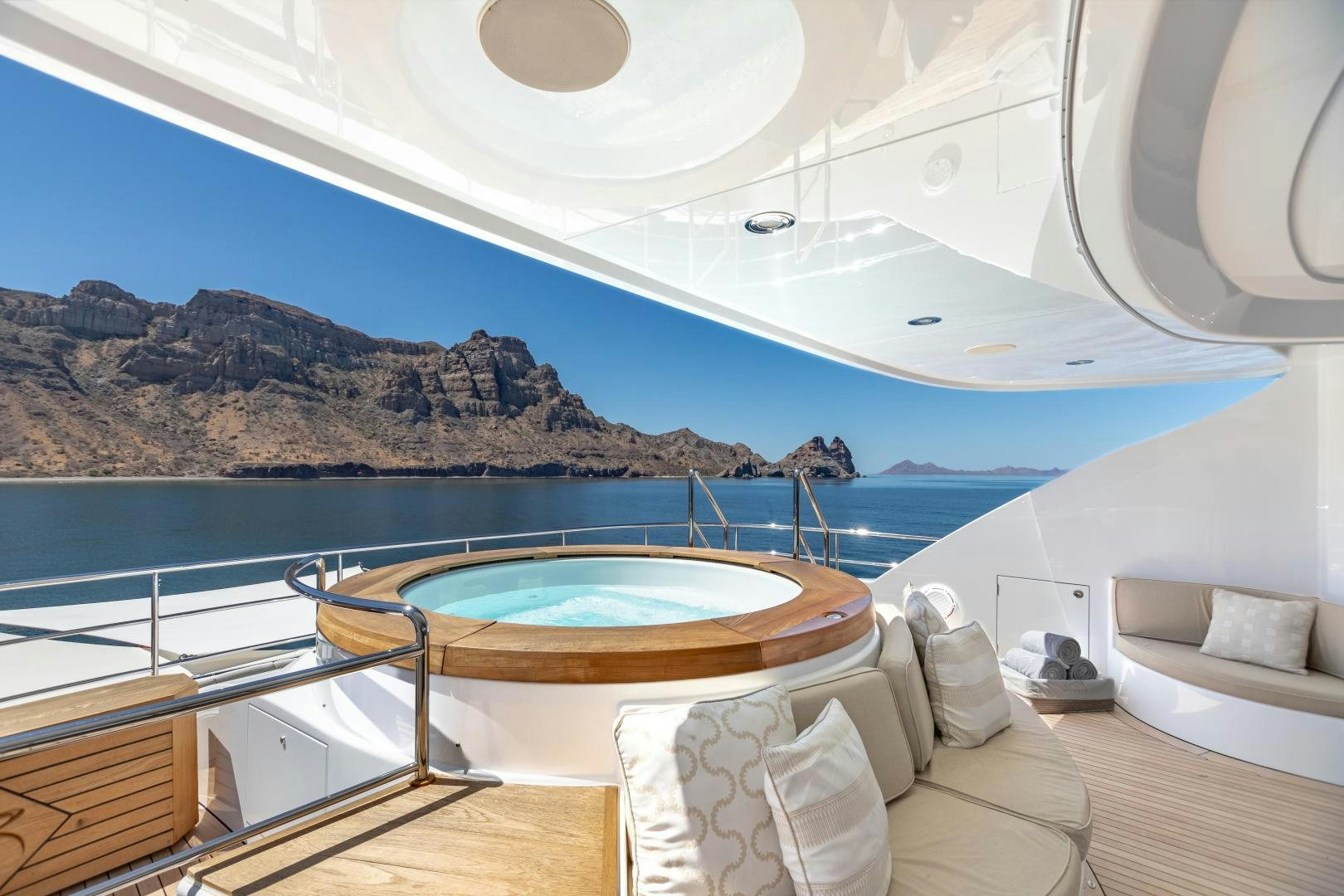 a large white tent with a pool and a view of the ocean aboard ROCHADE Yacht for Sale