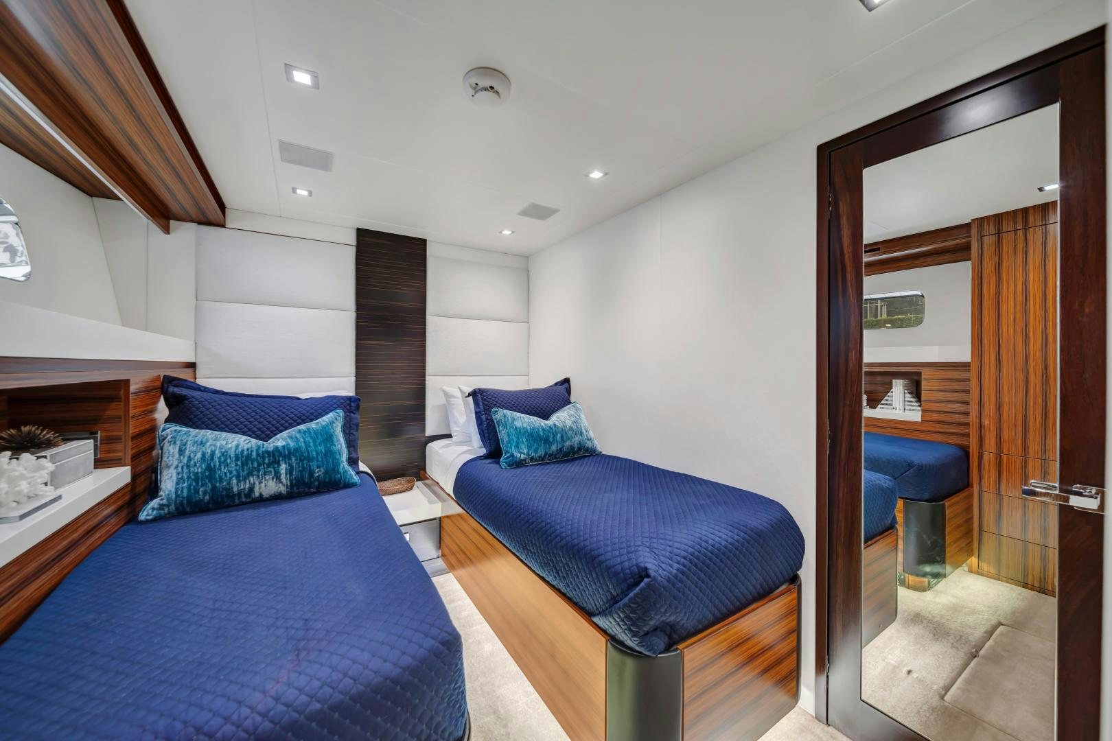 a bedroom with a bed and a fireplace aboard ON Q Yacht for Sale