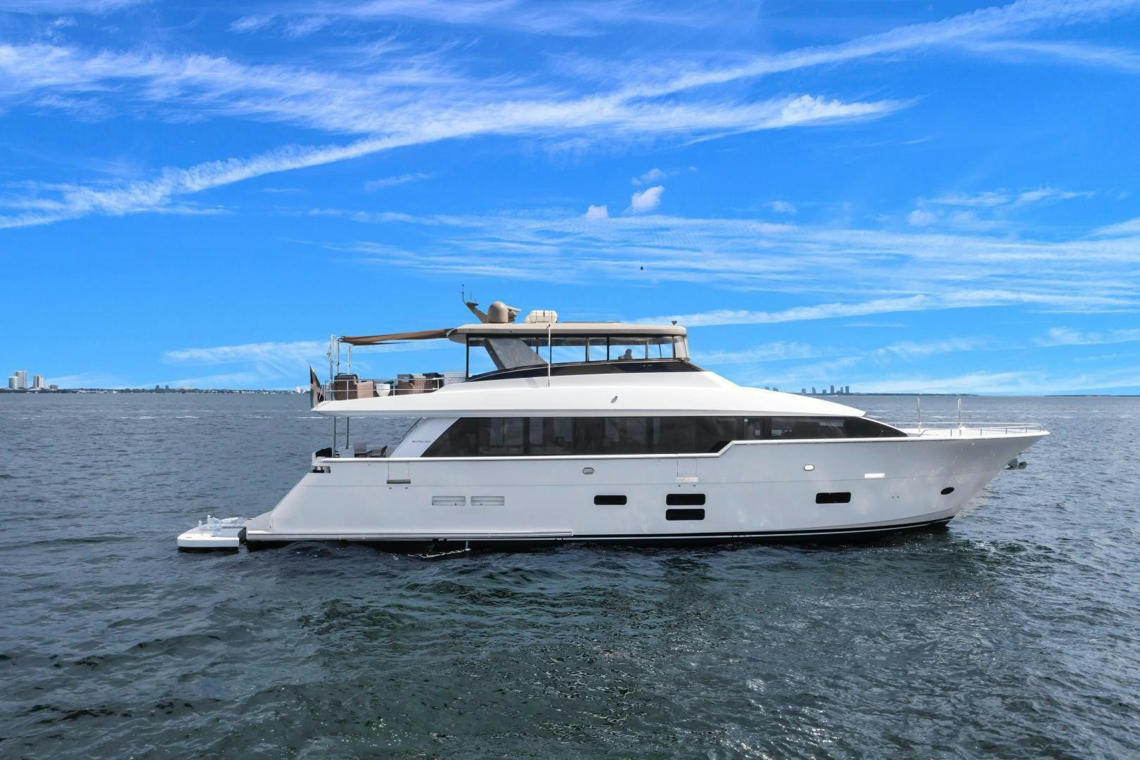 a white boat in the water aboard ON Q Yacht for Sale