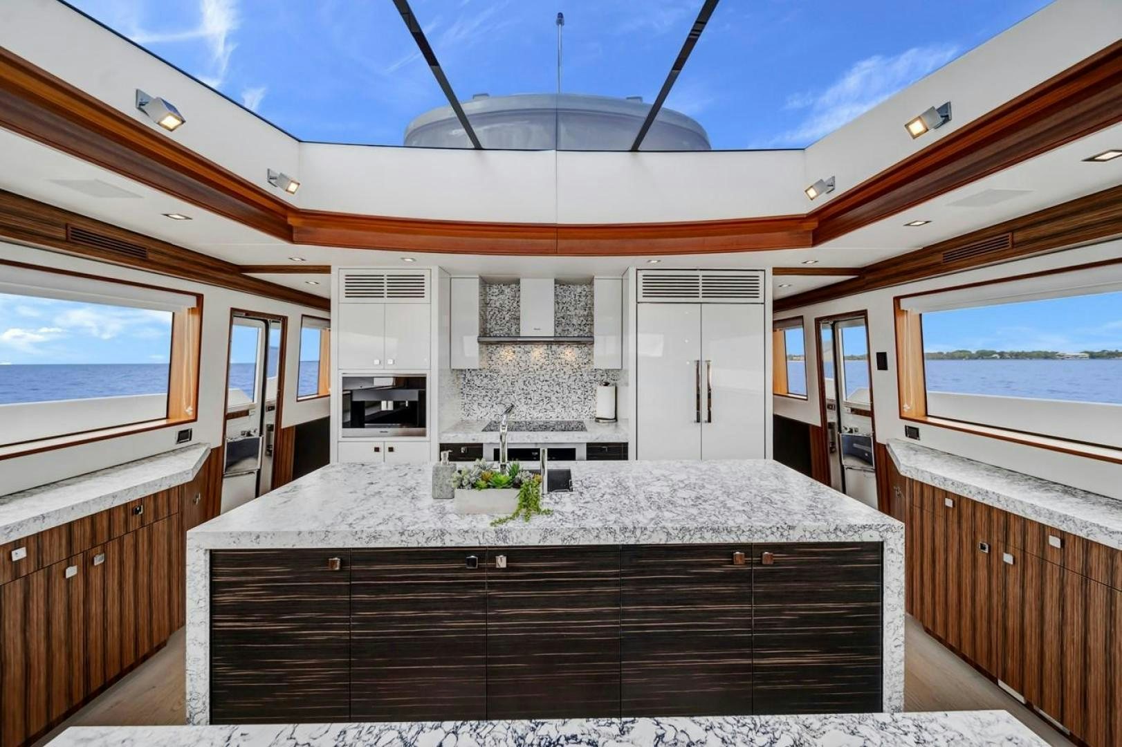 a kitchen with a large island aboard ON Q Yacht for Sale