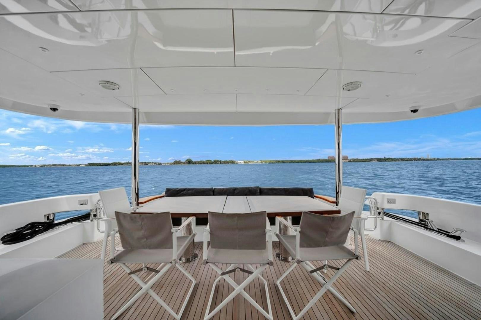 a table and chairs on a boat aboard ON Q Yacht for Sale