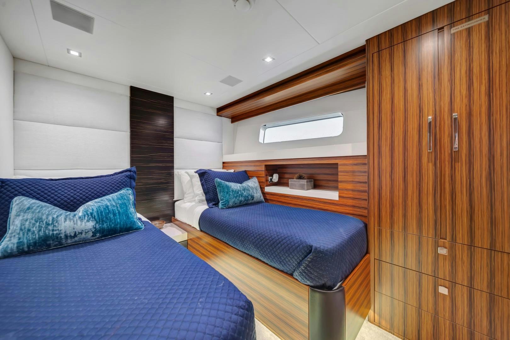 a bedroom with a bed and a closet aboard ON Q Yacht for Sale