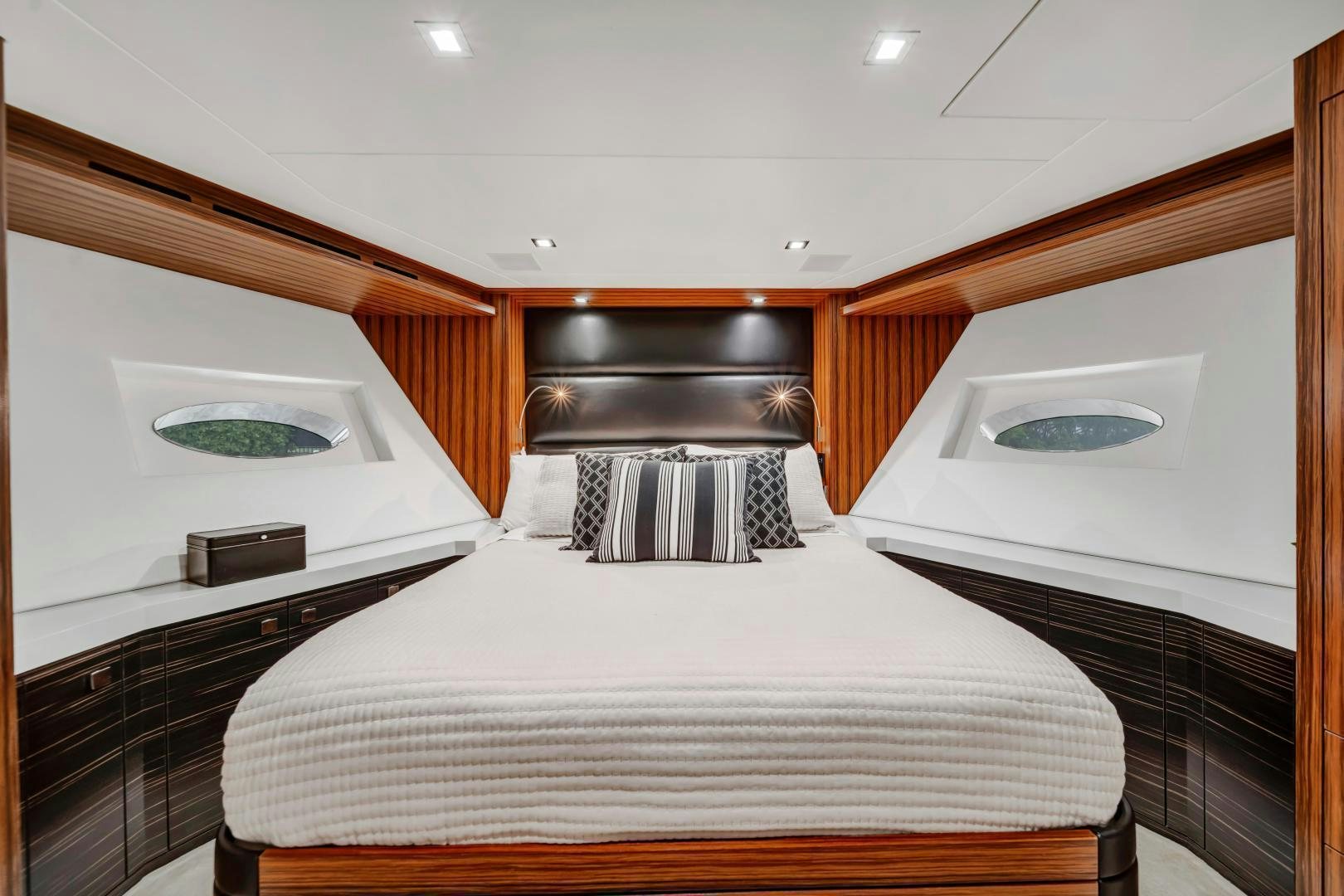 a bedroom with a bed and a microwave aboard ON Q Yacht for Sale